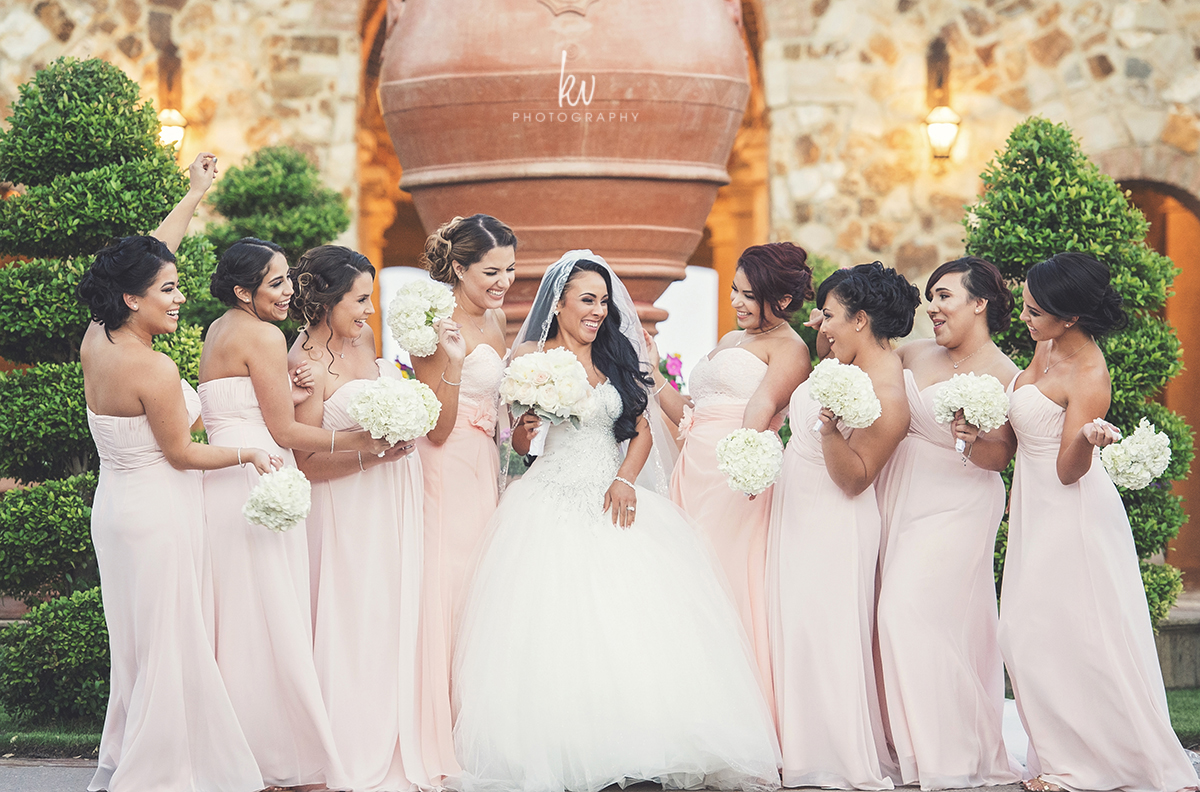 Bridesmaids laughing with Bride